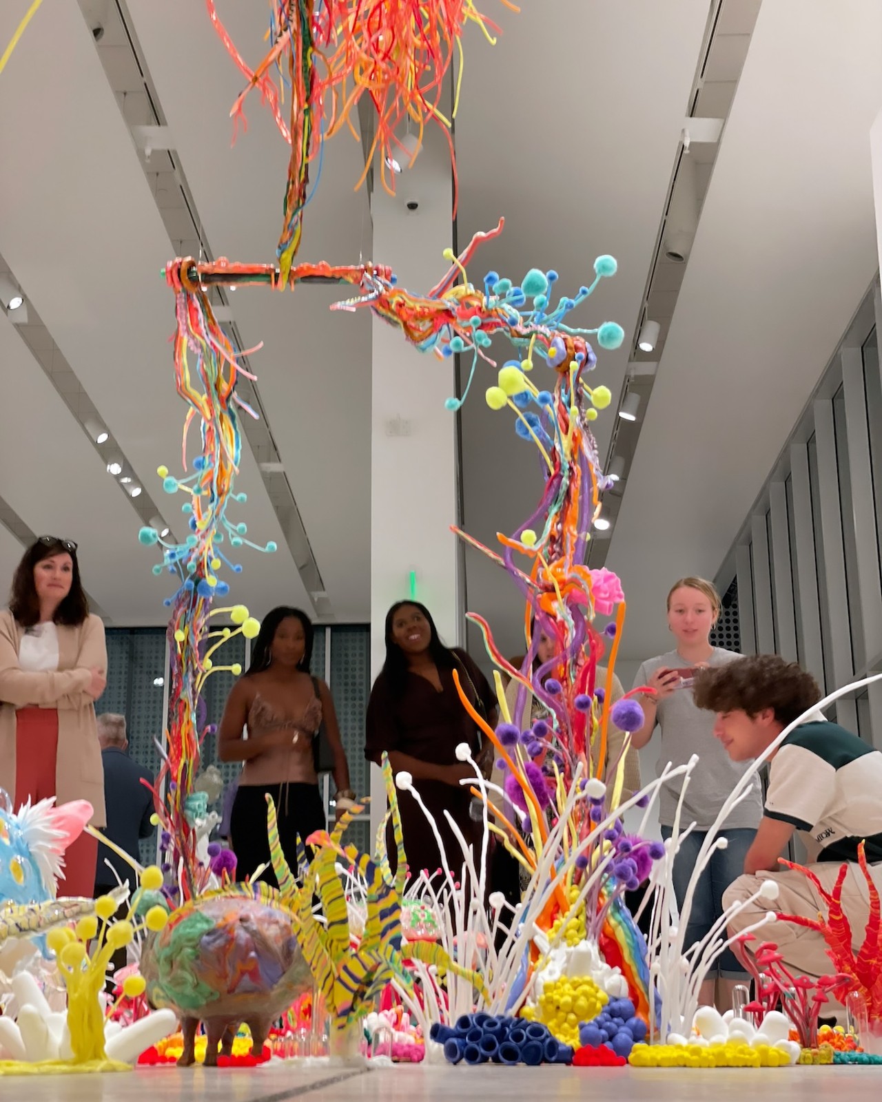 Sarasota artist Samo Davis created a 12-foot sculpture/puppet made of plastic, pompoms and mirrors that look like a colorful hallucination in the middle of Tampa Museum of Art.