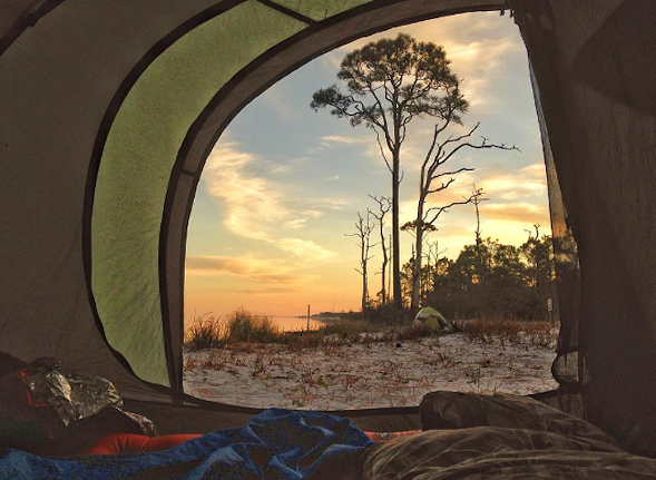 St. George Island State Park
    1900 E. Gulf Beach Drive, St. George Island, FL 32328 | 850-927-2111
    This campsite has 60 sites with water, electricity and other amenities, but for campers looking to step out into the real wilderness, two primitive sites can be reached by a 2.5 mile trail or by kayak. 
    
    Photo via fl.stateparks/Instagram