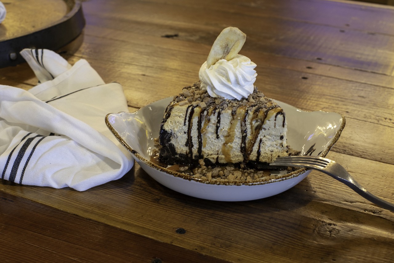 Studded with Heath bar and candy banana chips, the appropriately named Epic Peanut Butter Pie is light and fluffy in a house-made crushed Oreo crust topped with whipped cream, chocolate and caramel.