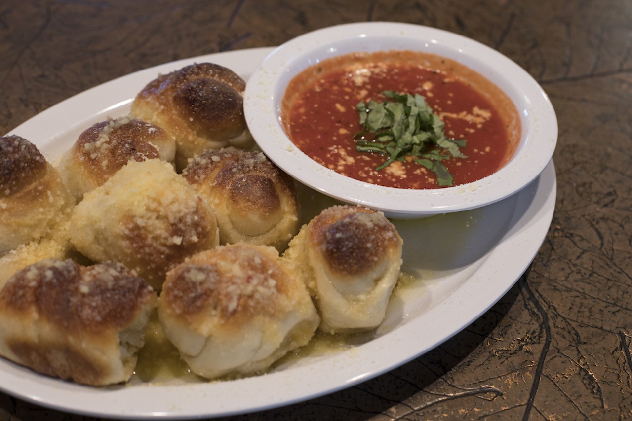 The overflowing pile of garlic knots, sprinkled with grated Parmesan and minced garlic.