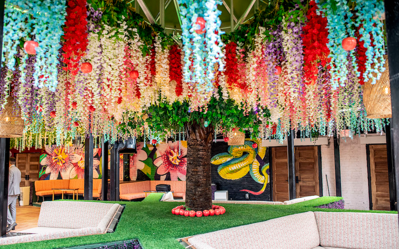 Tampa's two-story, paradise-themed Eden nighclub has three sections including the garden of Eden featuring massive amounts of flowers and vines, a mural by artist Matt Kress and a giant tree garnished with red apples.