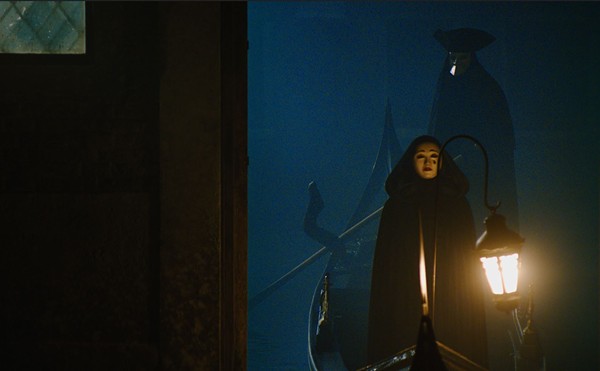 An ominous figure arrives by gondola to attend Mrs. Reynolds' séance in 'A Haunting in Venice'