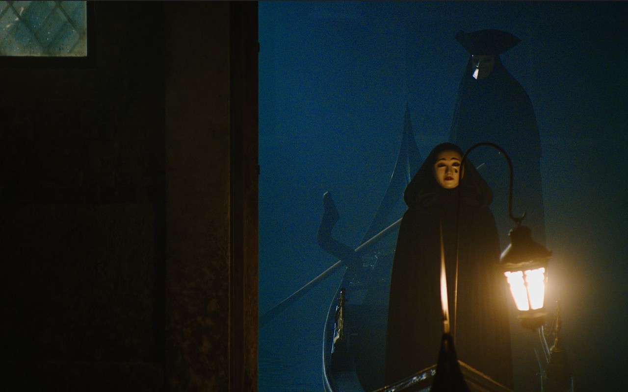 An ominous figure arrives by gondola to attend Mrs. Reynolds' séance in 'A Haunting in Venice'