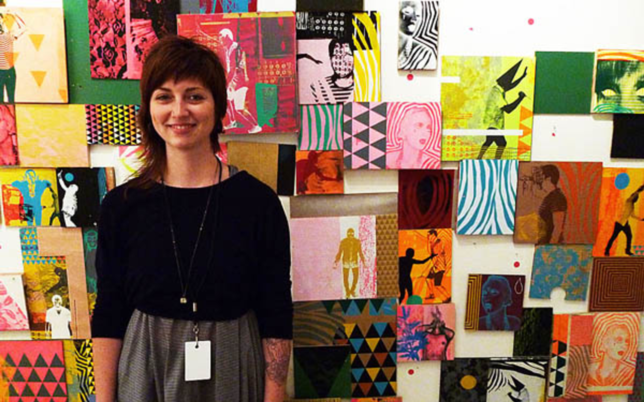RED DOT SPECIAL: C. Emerson Fine Arts assistant Kristen Bellomo stands in front of a grid of artworks by Rocky Grimes at SCOPE Miami.