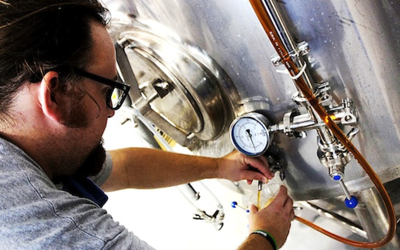 Big Storm Brewing Company's Mike Bishop pours some of their first batch of brew.