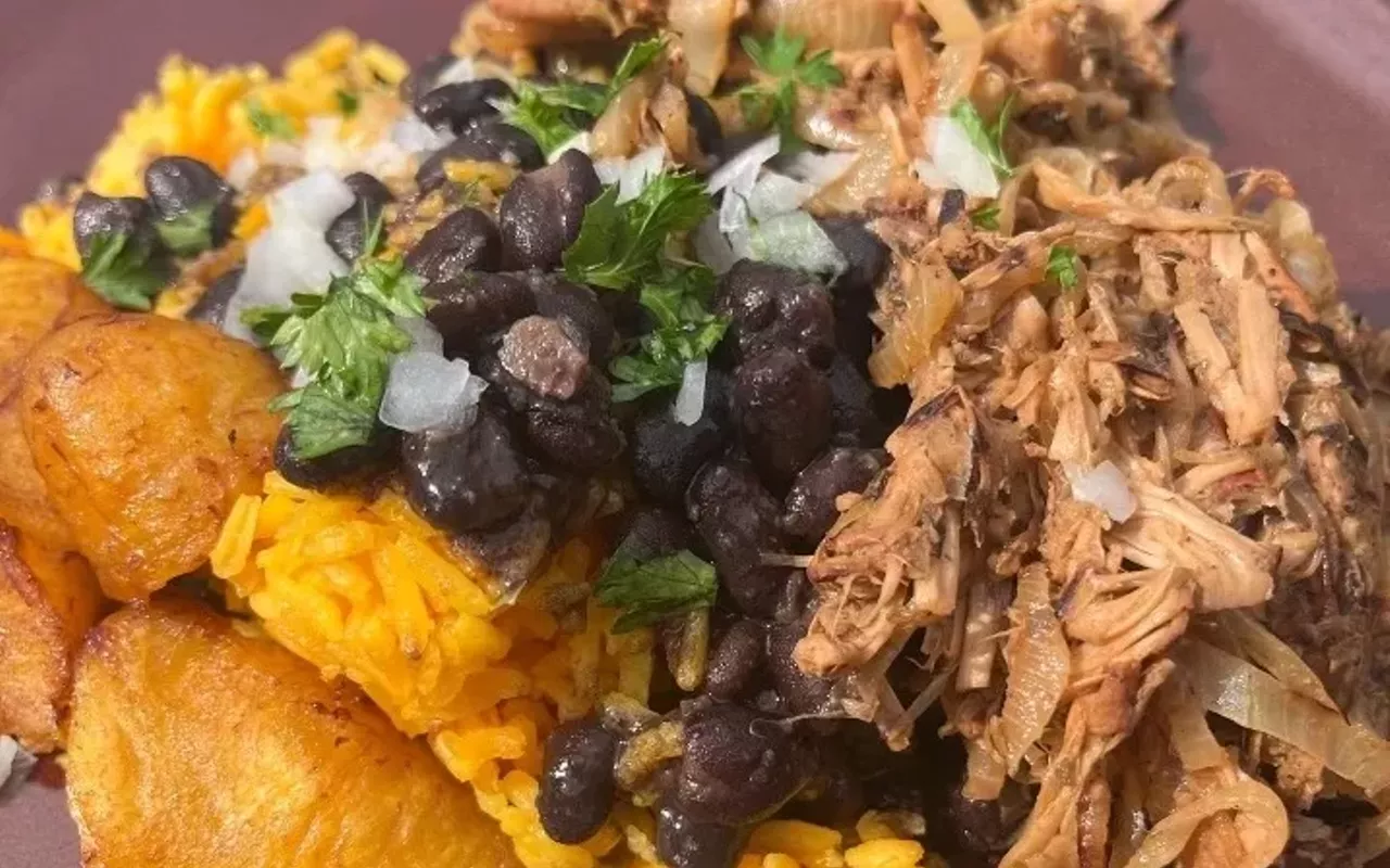 Vegan vaca frita with rice beans, and plantains.