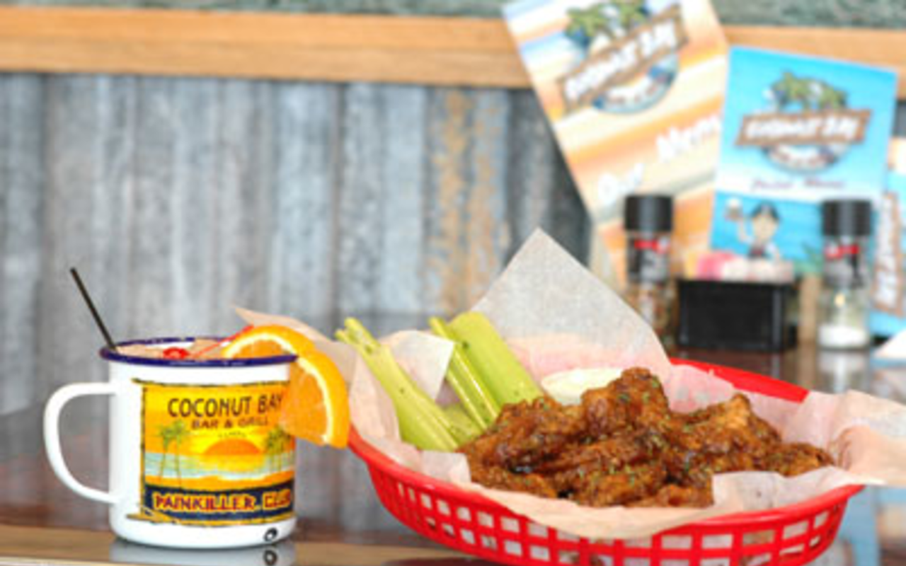 WING IT: A basket of Coconut Bay's way hot chicken wings, flanked by a "Painkiller" drink.