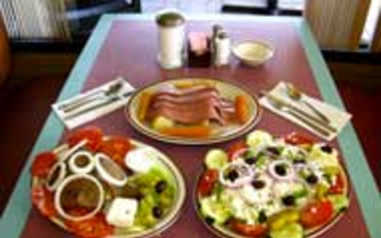 ON THE MONEY: Three Coins offers a smattering 
    of Greek specialties, such as (clockwise from lower 
    left) gyro  dinner with tzatziki sauce, corn 
    beef and cabbage, and Greek salad.