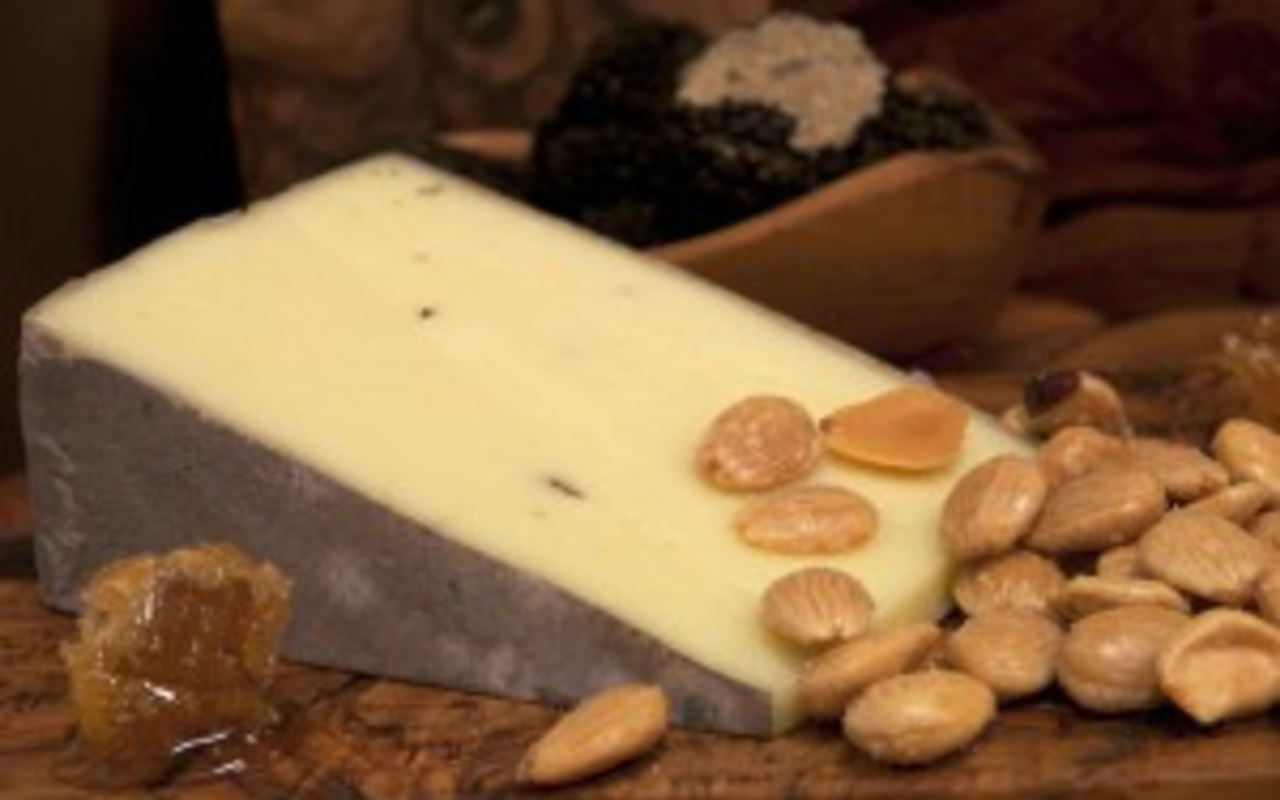 The Sottocenere's flavor comes from the bits of white and black truffles in it.