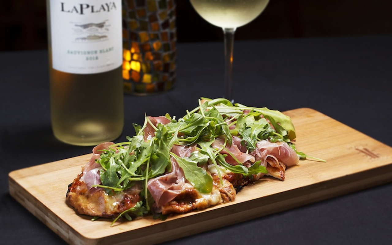 An After Dark flatbread with prosciutto and arugula.