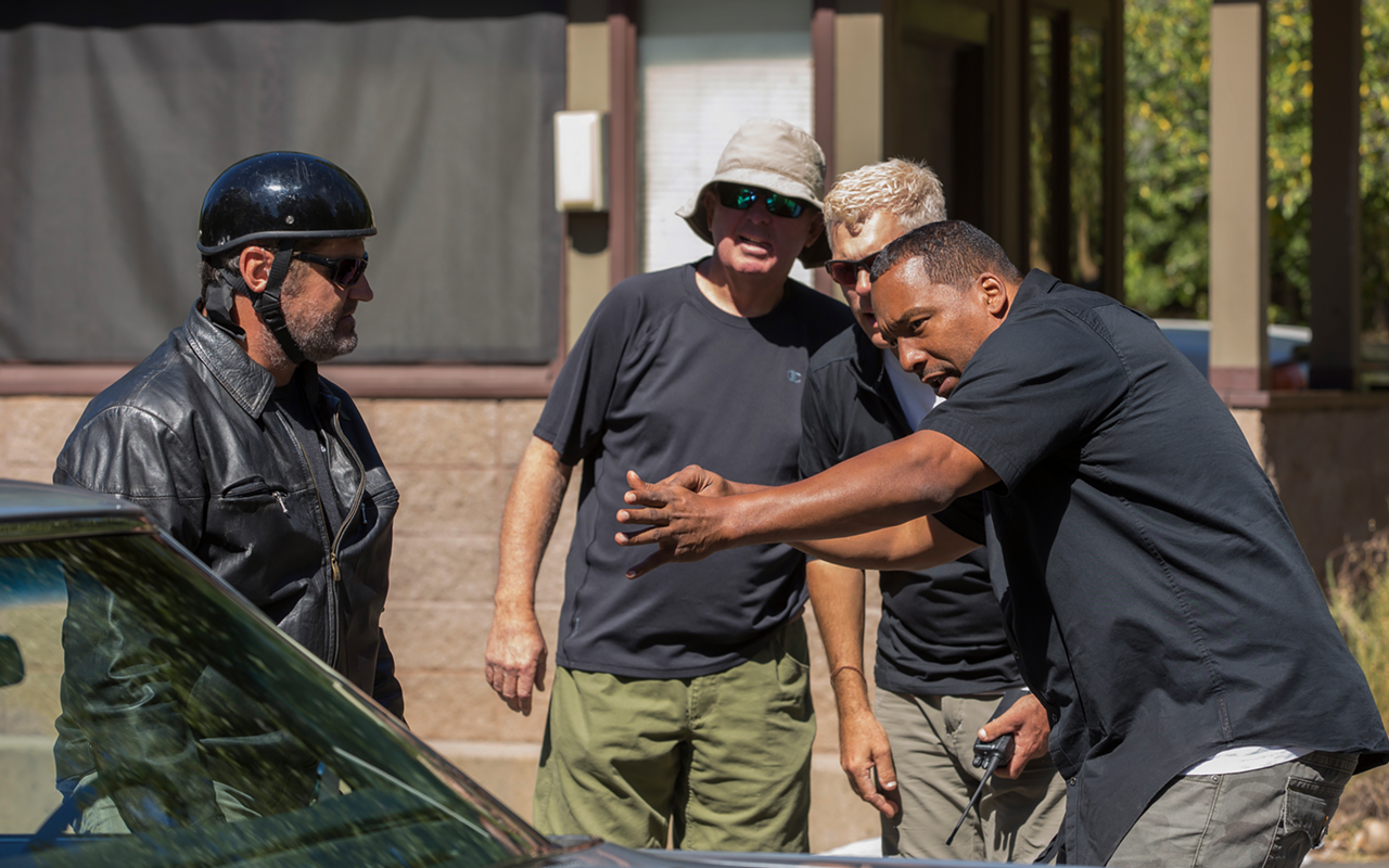 Deon Taylor (far right) talks to his cast and crew while setting up a scene in Traffik, his latest film, a genre thriller about human trafficking, journalism and fighting for survival.