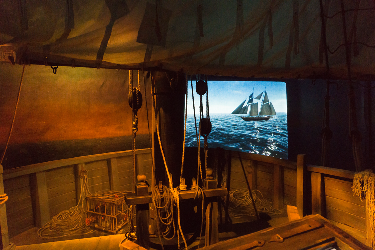The interactive theater is made to look like the hull of a pirate ship, with screens in front of you projecting the open seas.