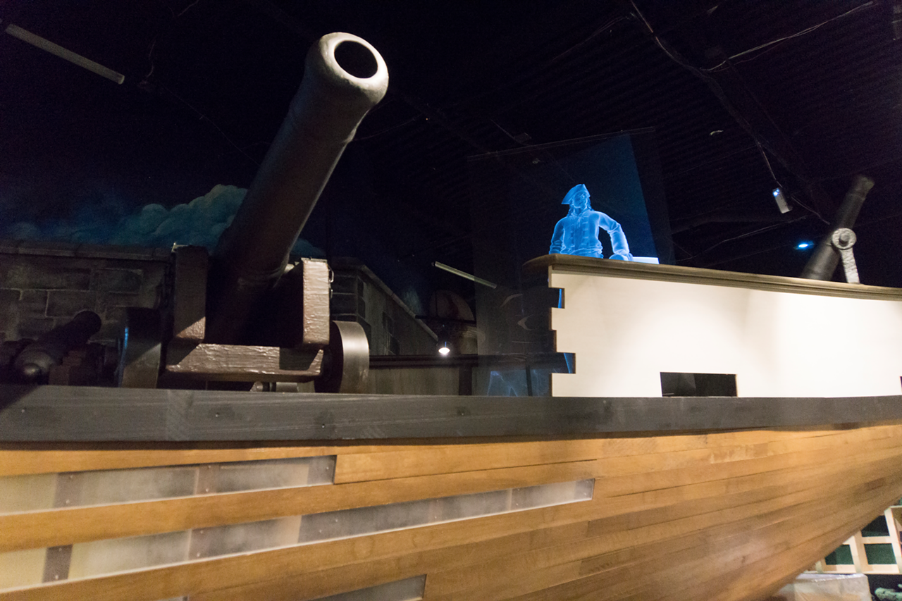 A 60 foot long replica Bermuda Sleuth sits in the center of the gallery, cannons and all.