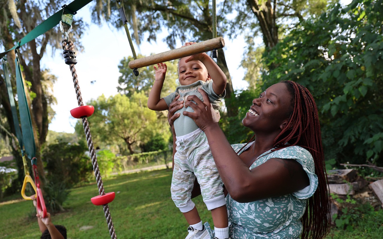 Jasmine Brown plays with her youngest son, Elijah, in the backyard of her home in Marion County, Fla., Thursday, Oct. 5, 2023.
