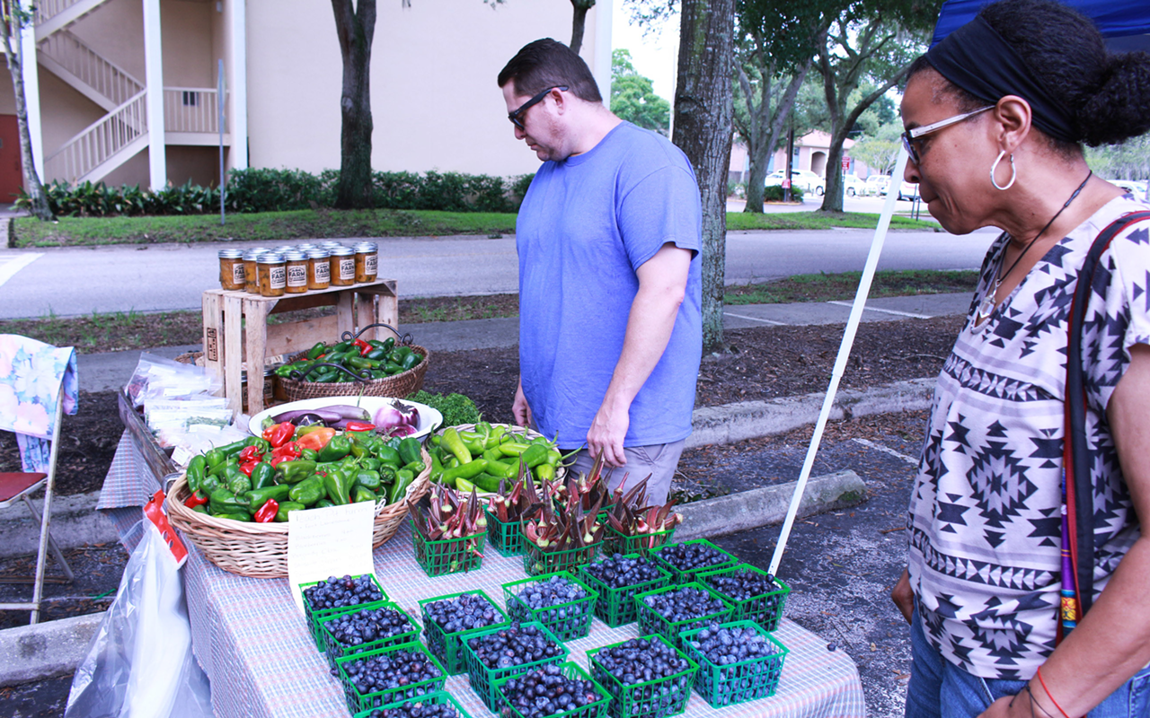 The Black Pearl's Chris Artrip peruses a booth at the Temple Terrace Farmers Market.