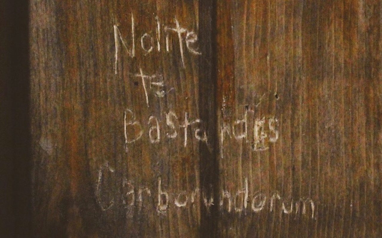 Offred's Latin message - which translates - "Don't let the bastards grind you down."