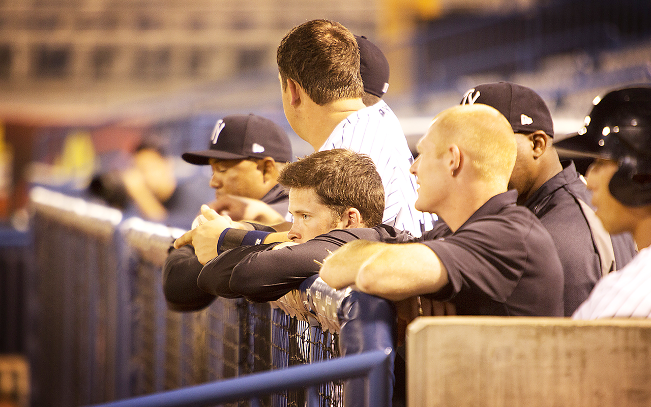 Tampa Yankees hanging out at the dugout fence.