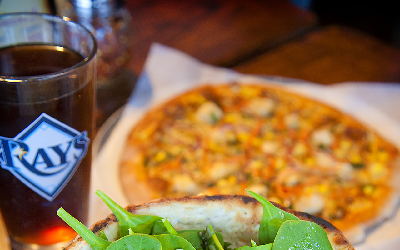 OPTIONS: The caprese salad, foreground, is served in a baked pizza-dough bowl; the Hippie’s Pie toppings include tofu, spinach and sun-dried tomato basil sauce.