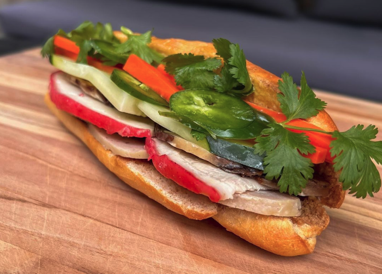 BackAlley Bánh Mì
Where to find it: In Between Days. @backalleybanhmi on InstagramOwner Viet Nguyen tells CL that his mother and grandmother’s cooking ultimately inspired his specialized bánh mì pop-up. “My mom is still cooking some of the best meals I’ll ever have and I’m still chasing recipes that I remember my grandmother used to make me, but could never emulate even after trying so many times. My idea was to introduce a from-scratch, highly specialized bánh mì shop where the labor of love could be tasted in every bite,” he explains. “All the recipes were my own mother’s recipes except for the bread. Bánh mì literally translates to ‘bread’ so for me, that’s the most important part and it took me years to master.” While the Back Alley menu is constantly changing with protein options like lemongrass chicken and tofu, Nguyen hopes to offer ten different banh mi options eventually—although his Đặc Biệt (aka ‘special’) with pork cold cuts and paté will most likely be a permanent player.
Photo via backalleybanhmi/Instagram