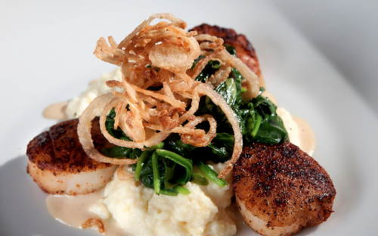 Spice-rubbed scallops atop spicy, cheesy grits and drizzled with red-eye gravy at Mise En Place.