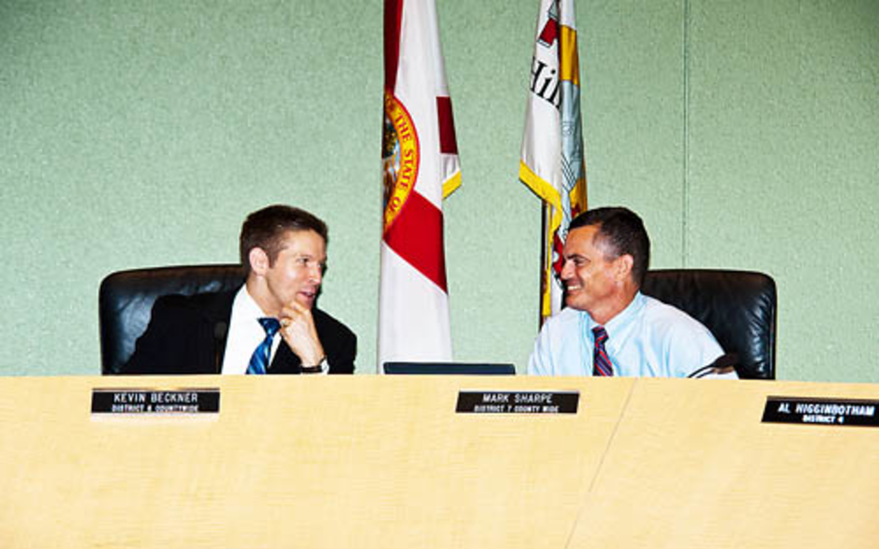 FACE TO FACE: Hillsborough Commissioners Beckner (left) and Sharpe confer before a budget meeting earlier this month.