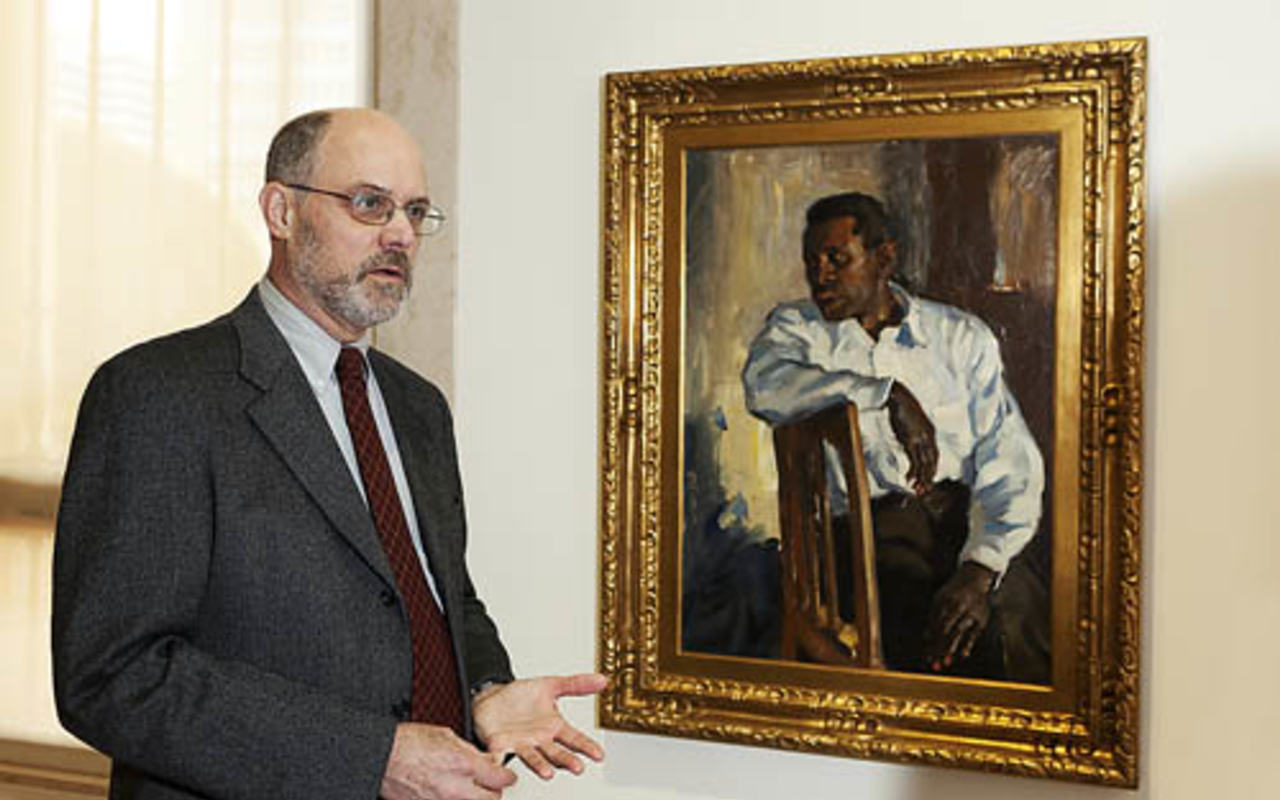 MFA director Lydecker with Randall Davey's portrait of actor/activist Paul Robeson.
