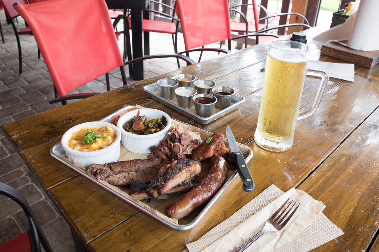 It's a platter with one sausage, a slice of Texas brisket, pulled pork, two St. Louis ribs, and two four-hour-smoked wings.