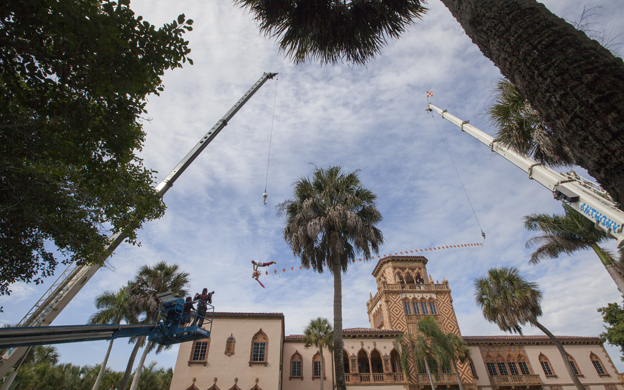 Chinese artist Li Wei soars 40 ft in the air, using the Cá d’Zan as a backdrop for his art at The Ringling on Monday, Nov. 17, 2014.