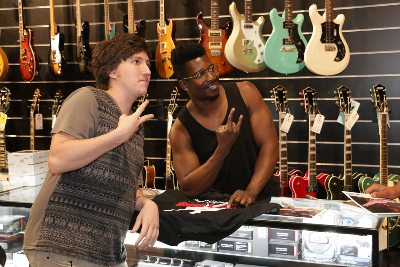 Tosin Abasi greets fans at Replay Guitar Exchange in Tampa, Florida on May 22, 2017.