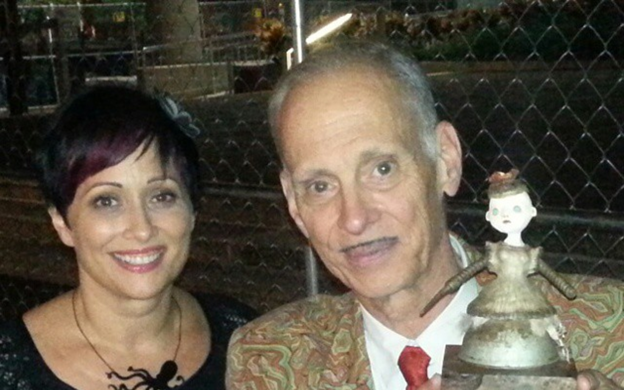 "STRANGE AND BEAUTIFUL": Artist Calan Ree and John Waters with the Lifetime Achievement Award she designed.