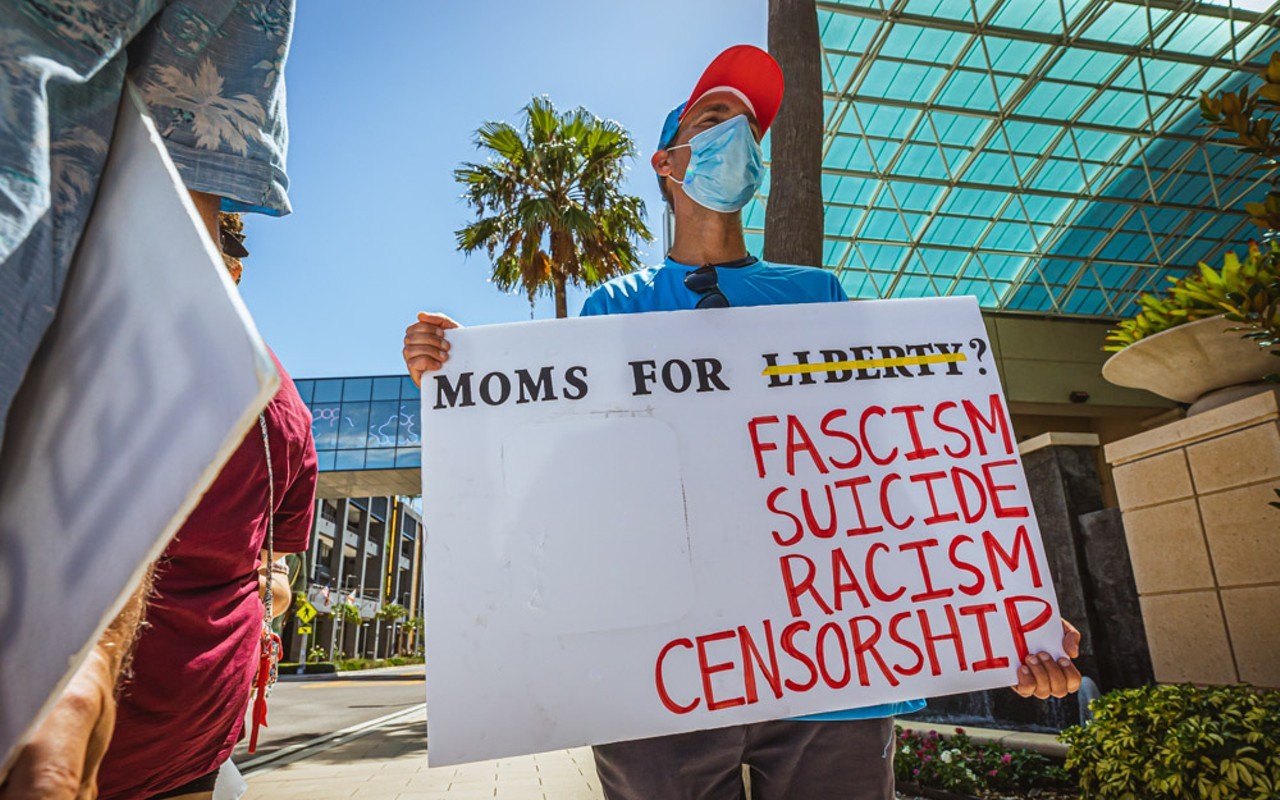A protester outside of the Moms For Liberty summit in downtown Tampa last July.