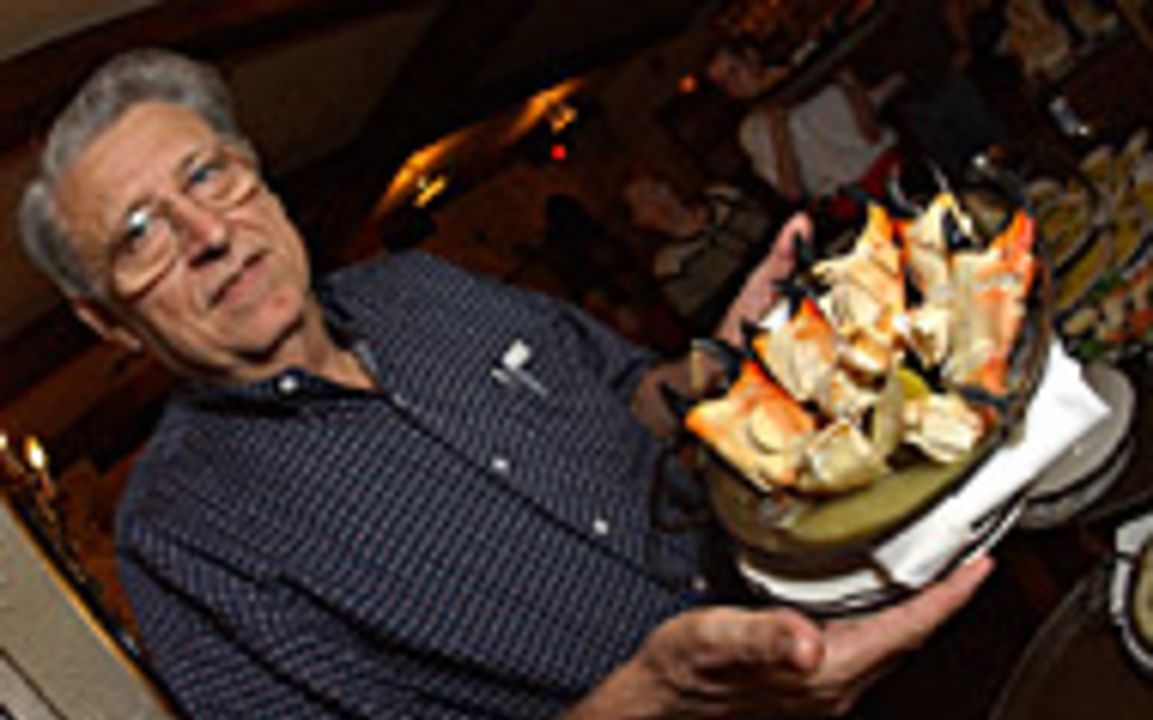 MAKIN' IT SNAPPY: Tio Pepe owner Jesus Exposito brandishes 
    a platter of stone crab claws.<i