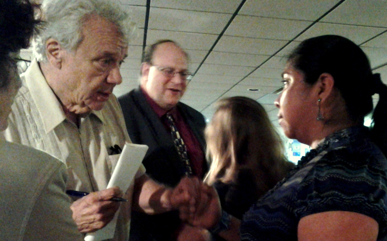 CIW member Lupe Gonzalo, right, talks with guests after her presentation at the Florida Holocaust Museum.