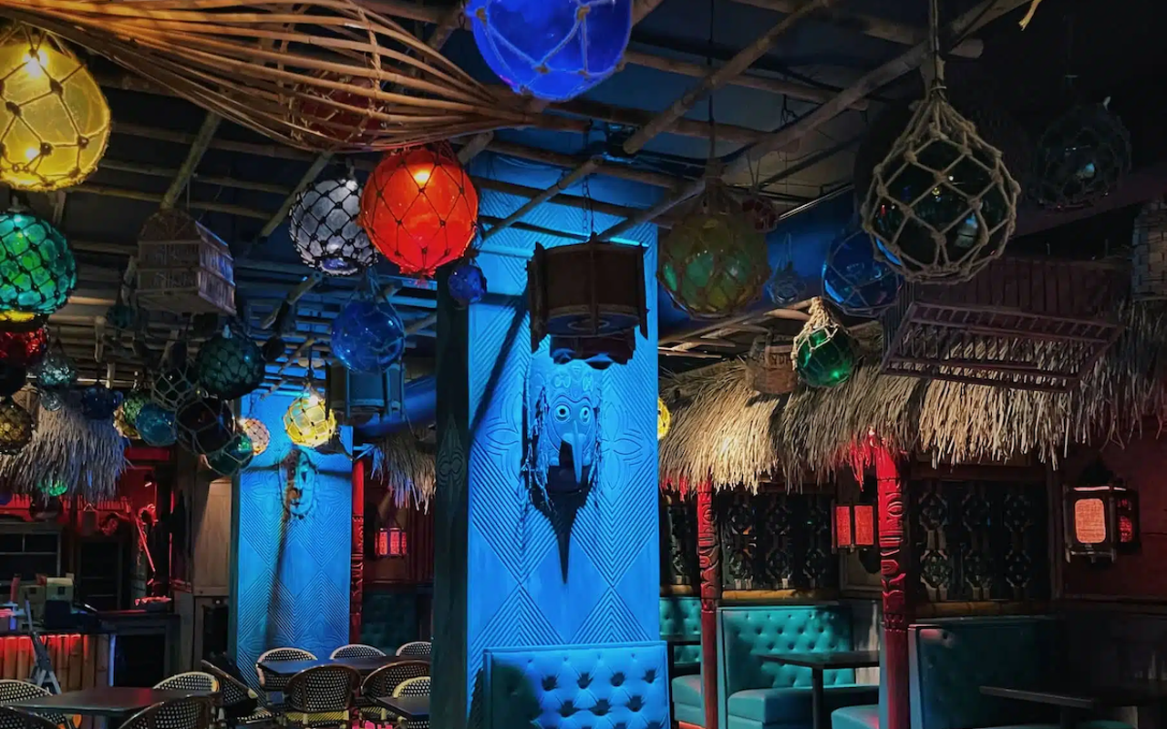 Don the Beachcomber's indoor seating comes complete with a small lamp for each table setting and ocean-green tufted booths encapsulated with ceramic tiles reminiscent of breeze blocks.