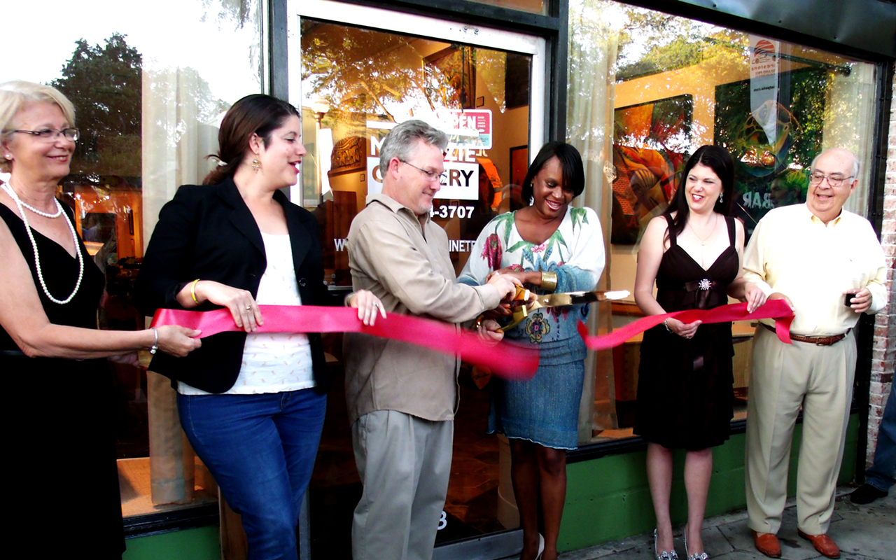 MAKING IT OFFICIAL: At center cutting the ribbon Sean McKenzie left, and Deputy Mayor Kanika Tomalin.