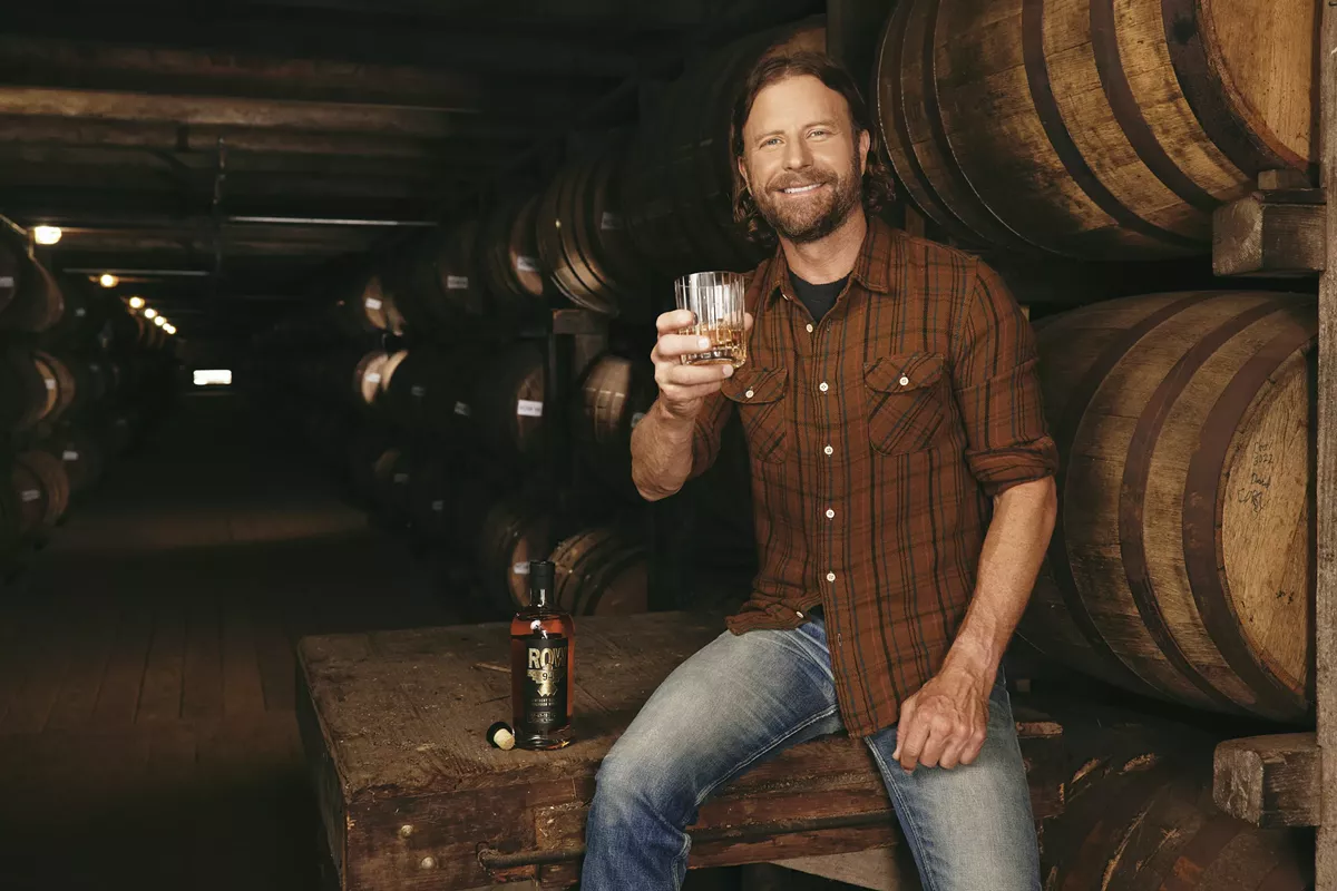 Country music star Dierks Bentley signs bottles of ROW 94 Bourbon at Luekens Wine & Spirits