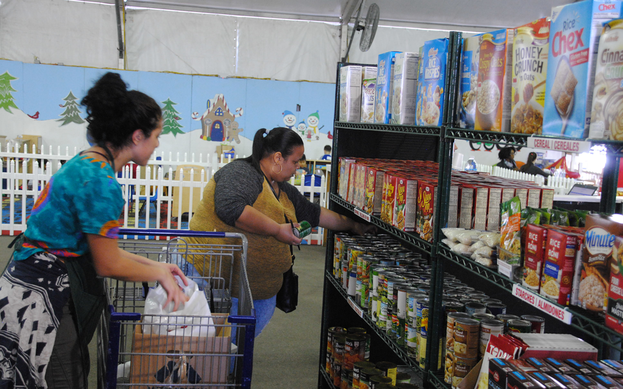 Two ladies selecting food for their families in the Shopping Area