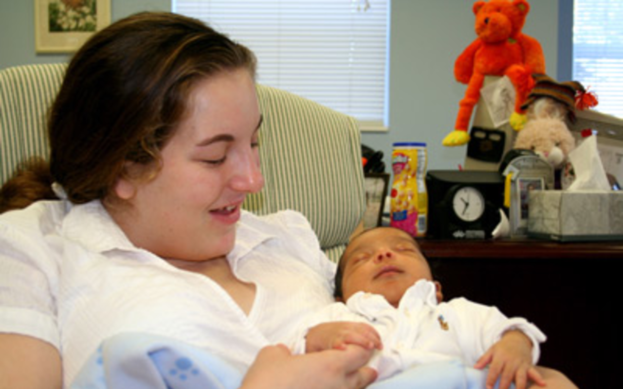NEW BABY, NEW SKILLS: Emily holds her 3-week-old son, Jessie, at Alpha House.