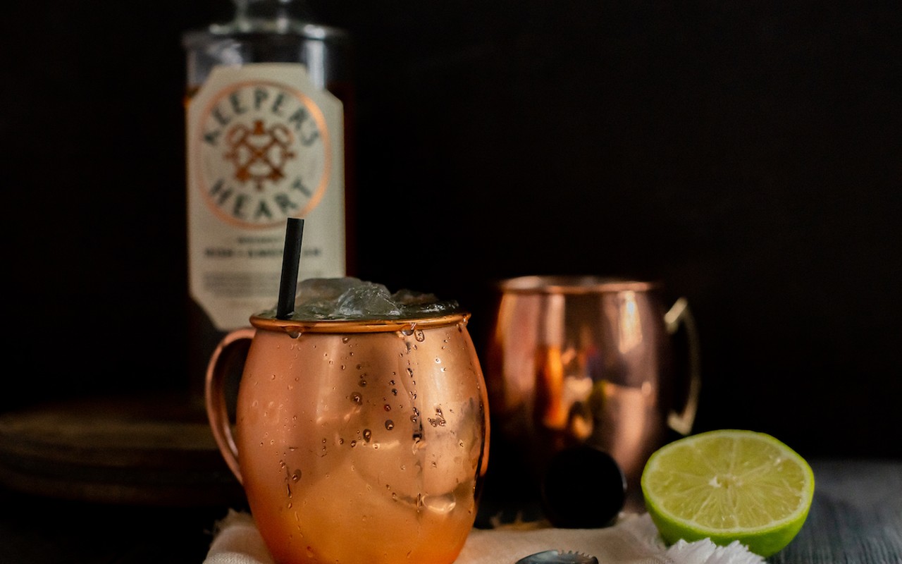 A copper mule cup with the Keeper's Heart branded whiskey inside