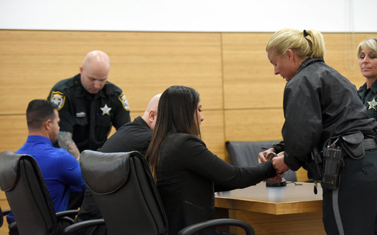 Caballero and Alvarez being handcuffed after their conviction.