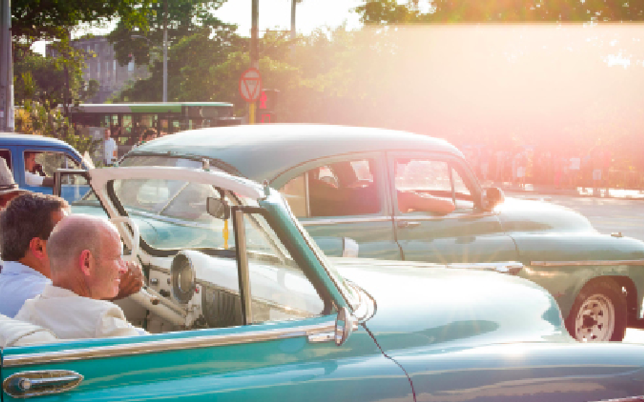 HAVANA RIDE: In Elaine Litherland's “Cuba,” a Havana street is jammed with patched-up early-model American cars.