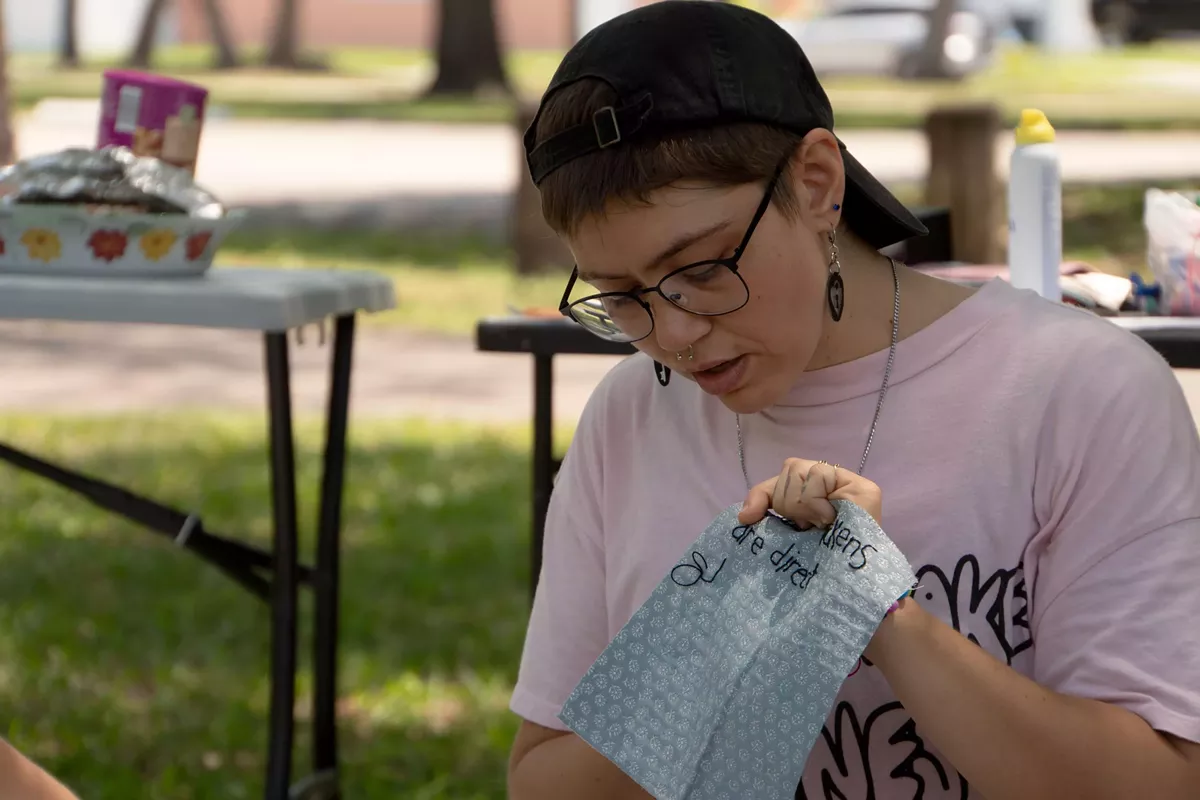 Now on View artist Mia Makes It leads an embroidery workshop in Al Lopez Park. Participants embroidered a one to two-sentence reflection on Tampa&rsquo;s past and present on a small square. Mia will stitch the community-created patches together with her own at HCC Ybor during Now on View.