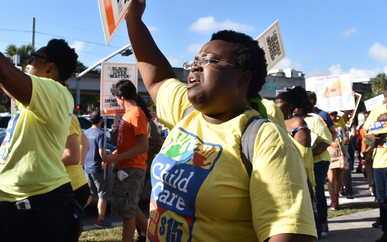Nadaije Paul Jajoute, a Hillsborough County Child-care worker, protests outside the GOP debates in Miami.