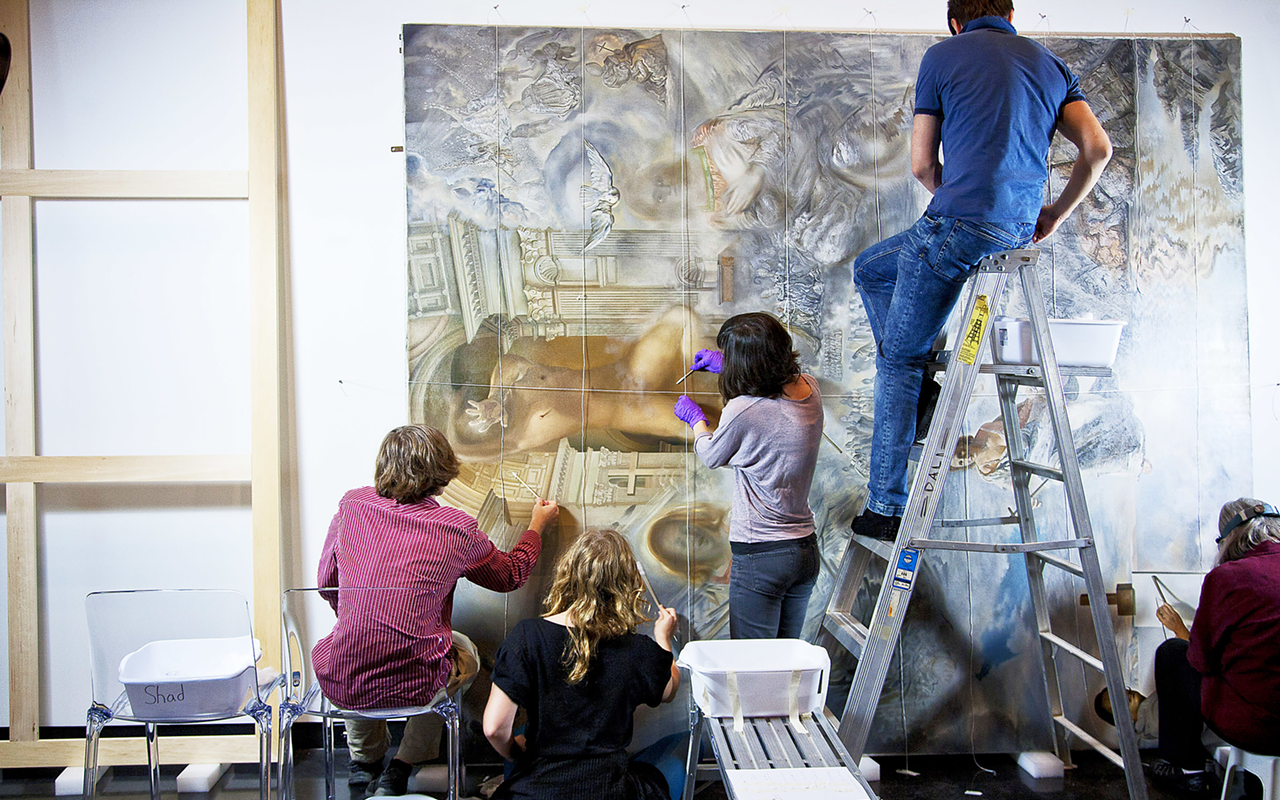 RELIGIOUS DETAIL: Restorers labor over “The Ecumenical Council (1960)” during the Dali Museum’s open restoration exhibition.