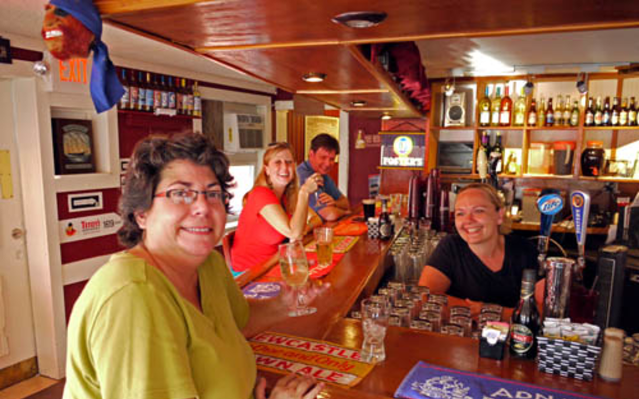 Lori Rosso (sitting at bar) and Kate Sailes (behind bar) at Village Pub.