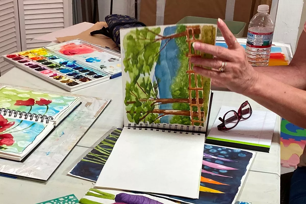 Artist creating artwork at Open Studio