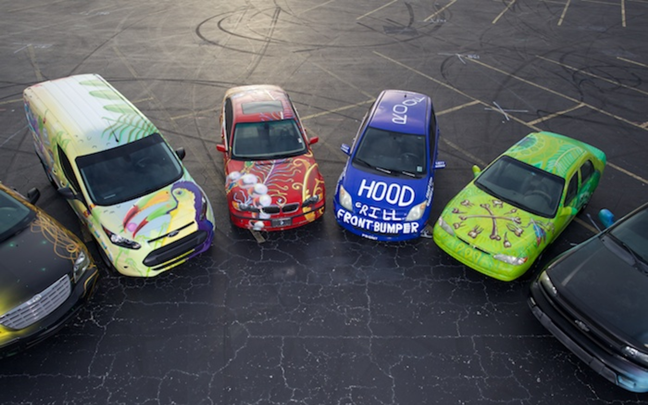 AUTO SHOW: The Carmada fleet includes (center) a red BMW adorned by Sebastian Coolidge and James Oleson, and Hunter Payne's "blueprinted" Scion for Mitzi Gordon.