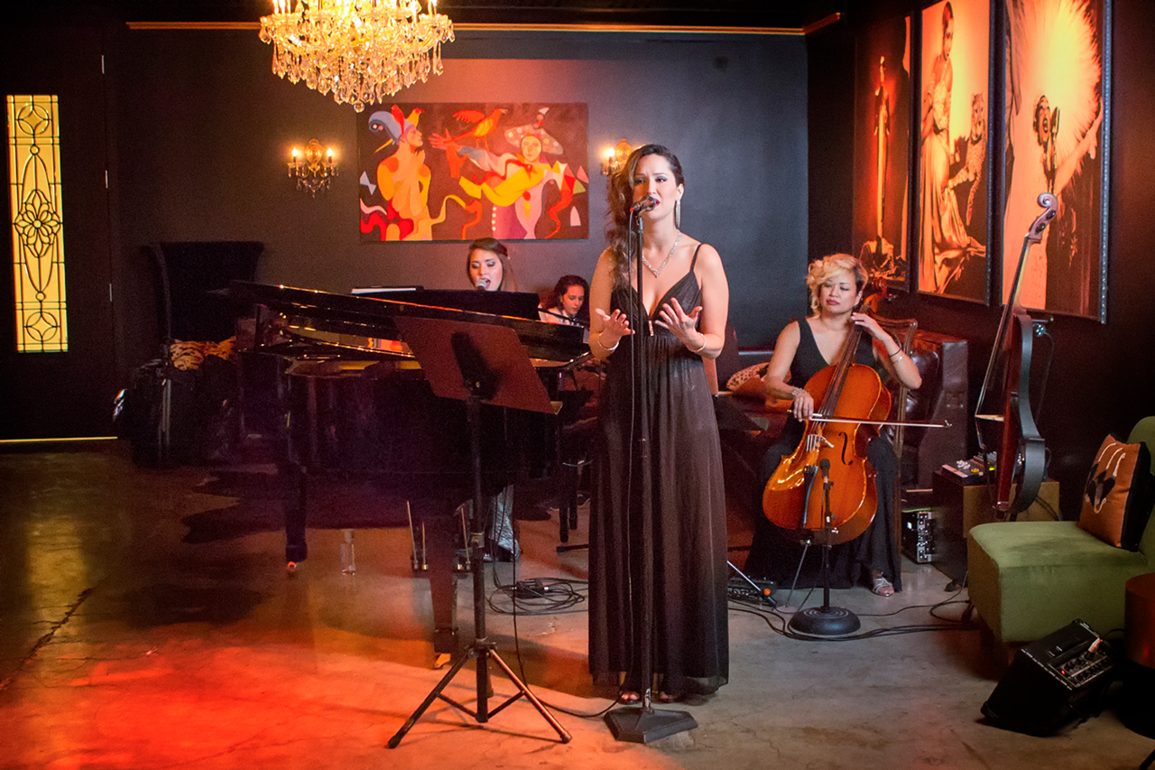 A live ensemble inside, with Tania Enriquez on vocals, Melissa Petrescue on piano, and Rose Mallare on cello.