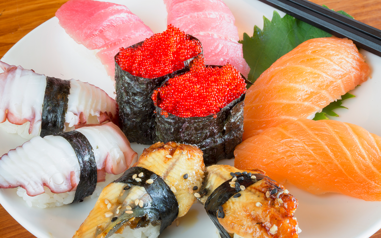 A nicely presented assortment of nigiri, offering octopus, tuna, salmon and eel with a tobiko roe center.
