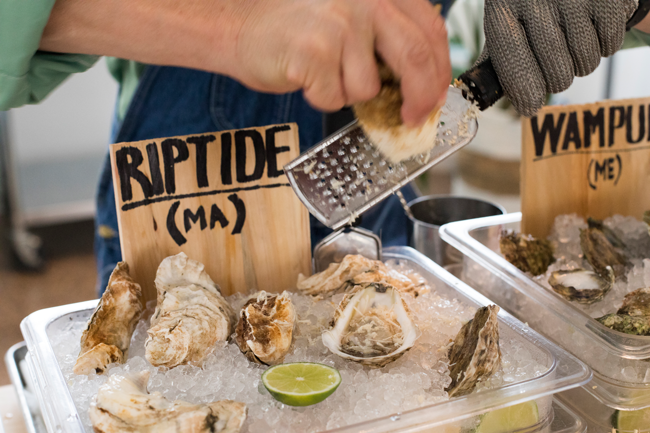 Owner Kevin Joseph tops a Riptide oyster with a touch of freshly grated horseradish.